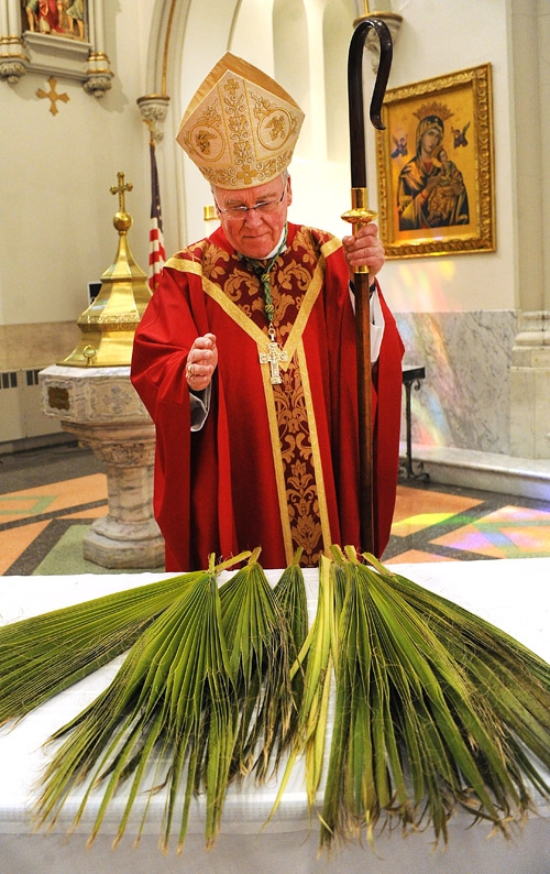 Bishop Richard Malone blessed the palms at St Joseph Cathedral on Palm Sunday. (Dan Cappellazzo/Staff Photographer)